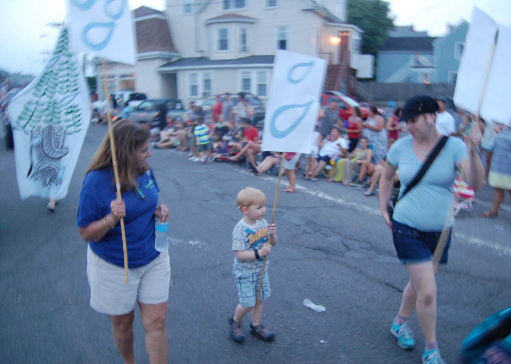 Jo-Ann Castano (left), Evan and KT Toomey march up Railroad Avenue. (Greg Cook)