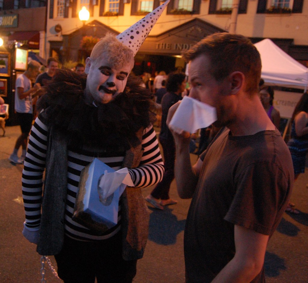 Drabby The Sad Clown (Tom Bush) offers an attendee a tissue.