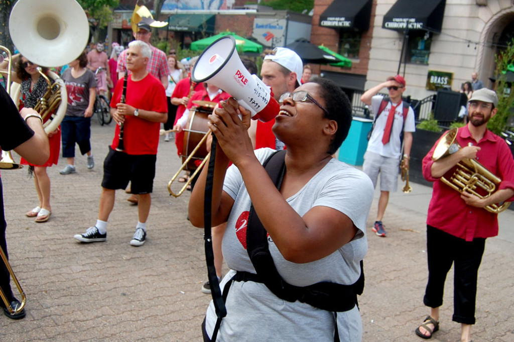 Deidra Montgomery, one of the festival organizers, leads chants during the festival's closing parade. (Greg Cook)