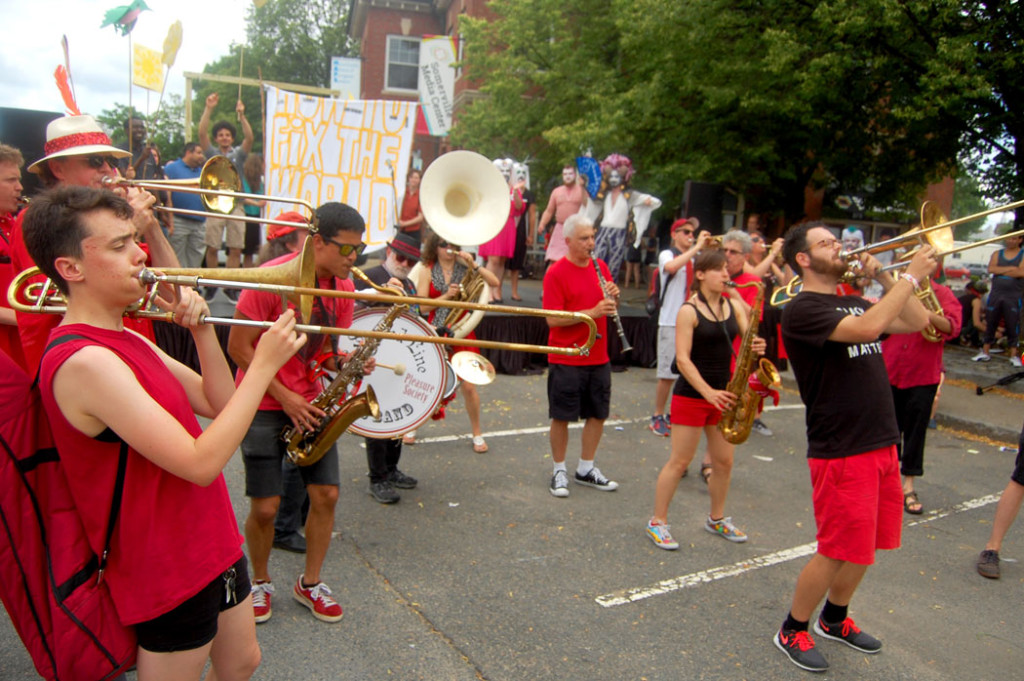 The Second Line Social Aid and Pleasure Society Brass Band plays during the festival's closing rally. The band combines music with social action, performing at protests and peace rallies, as well as helping organize Somerville’s annual Honk festival of activist street bands. (Greg Cook)