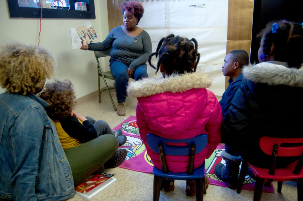 Tanya Nixon-Silberg of Wee The People leads a social justice story time at the Frugal Bookstore in Roxbury, Dec. 16, 2017. (Greg Cook)