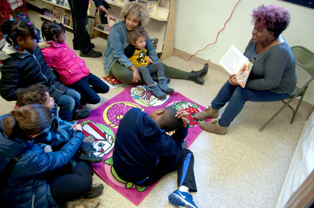 Tanya Nixon-Silberg of Wee The People leads a social justice story time at the Frugal Bookstore in Roxbury, Dec. 16, 2017. (Greg Cook)