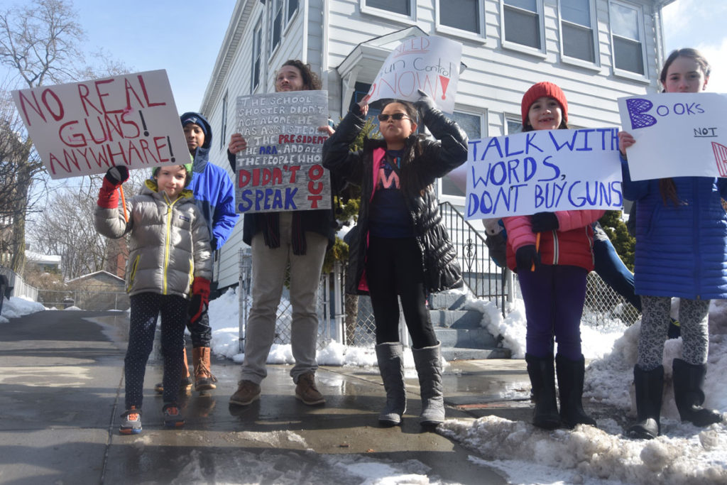 "No real guns! Anywhare!" "Talk with words, don't buy guns." Elementary students from Cambridgeport School protest guns on Broadway in Cambridge, March 15, 2018. (Greg Cook)