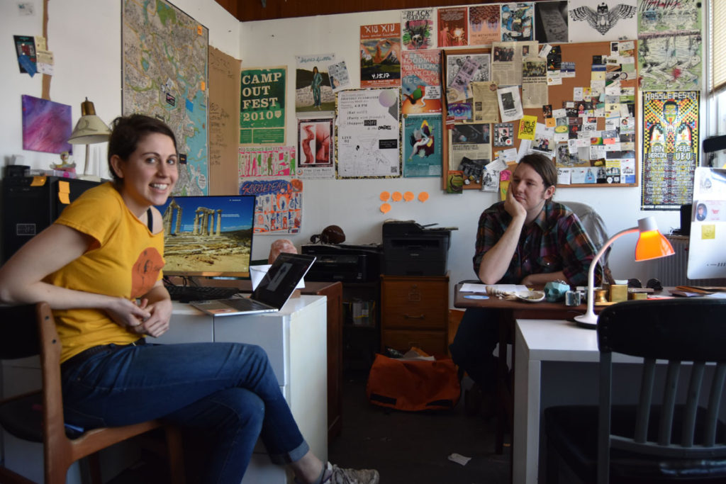 Emma Levitt (left) and Samuel Potrykus at the offices of the Boston Compass at Dorchester Art Project in Boston, May 2, 2018. (Greg Cook)