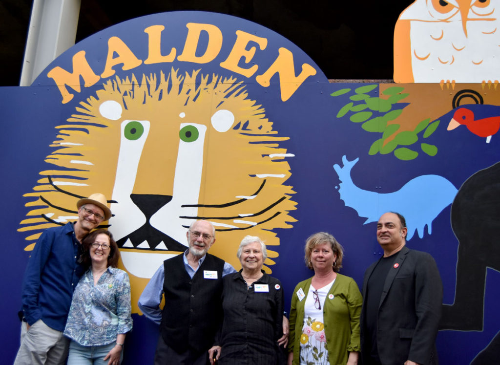 The Emberley family of illustrators. From left, son Michael Emberley and his wife Marie-Louise Fitzpatrick, Ed and Barbara Emberley, daughter Rebecca Emberley and her husband, musician Peter Black at "The Wonderful World of Ed Emberley" mural on Exchange Street, Malden, May 23, 2018. (Greg Cook)