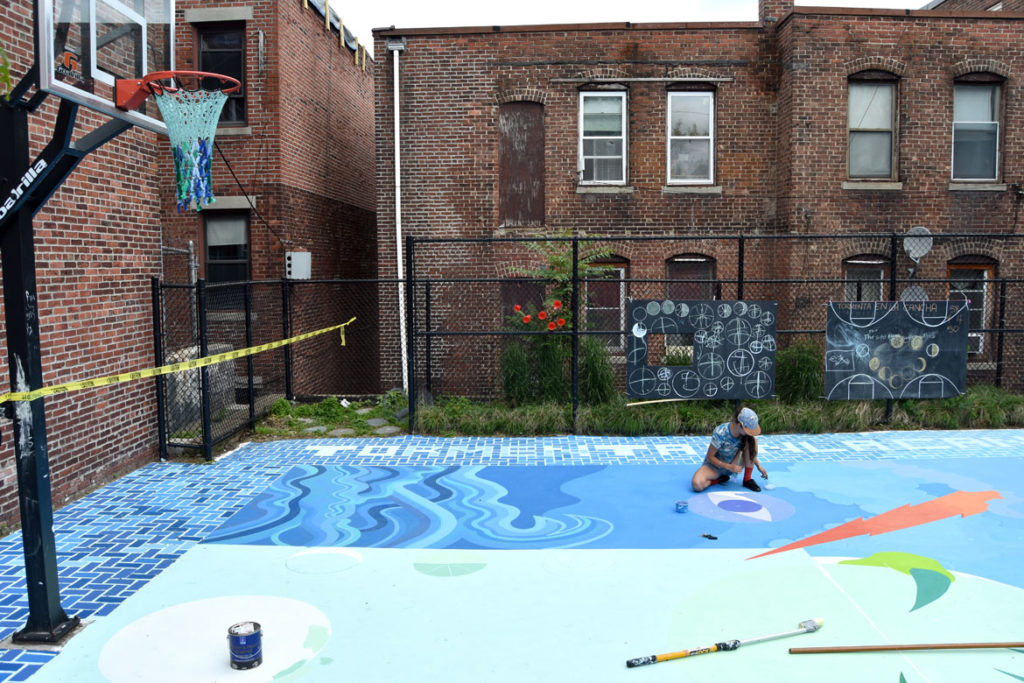 Maria Molteni paints her “Storming the Court” mural in Salem, June 13, 2018. (Greg Cook)