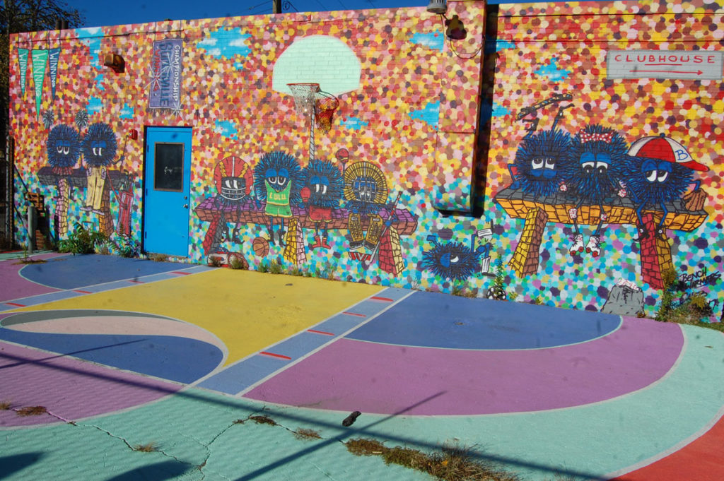 Maria Molteni's first basketball court mural at the (now defunct) art and sports Clubhouse at 471 Somerville Ave. in Somerville in 2016. Caleb Neelon painted the wall. (Greg Cook)