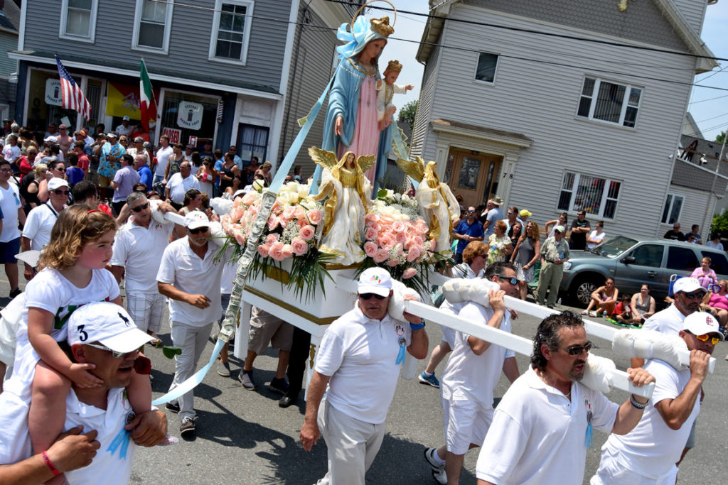 Carrying the Mother of Grace statue up Washington Street during Sunday's procession, July 1, 2018. (Greg Cook)