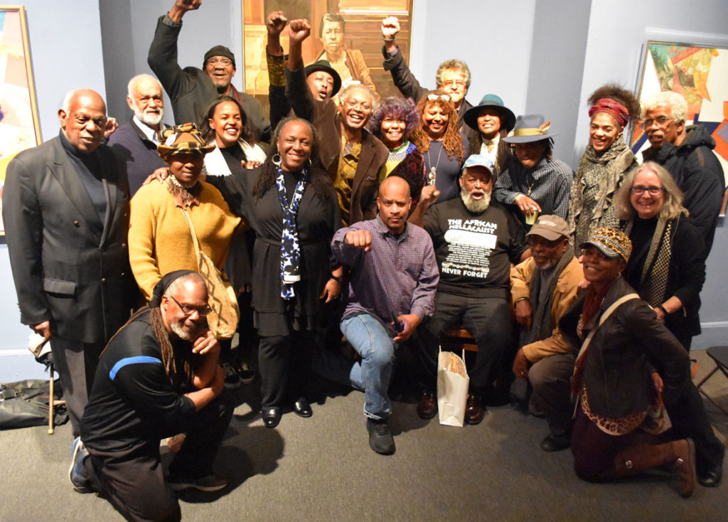 Members of the African American Master Artists In Residence Program and friends gather at a celebration of founder Dana Chandler (seated in black shirt) at the Museum of the National Center of Afro-American Artists in Roxbury, Nov. 3, 2018. (Greg Cook)