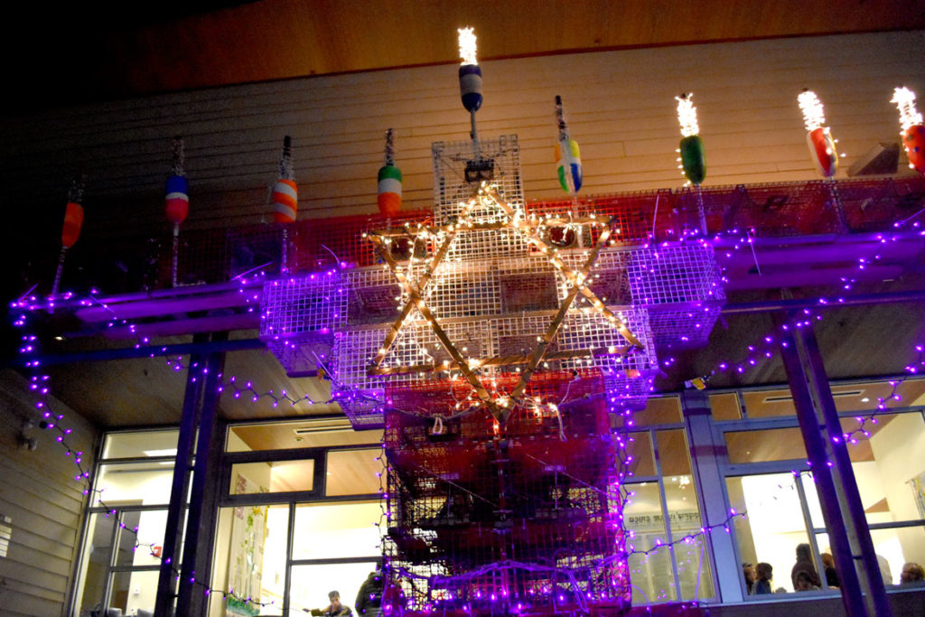 Lighting the Lobsta Trap Menorah for the third night of Hanukkah at Temple Ahavat Achim, Gloucester, Dec. 4, 2018. (Greg Cook)