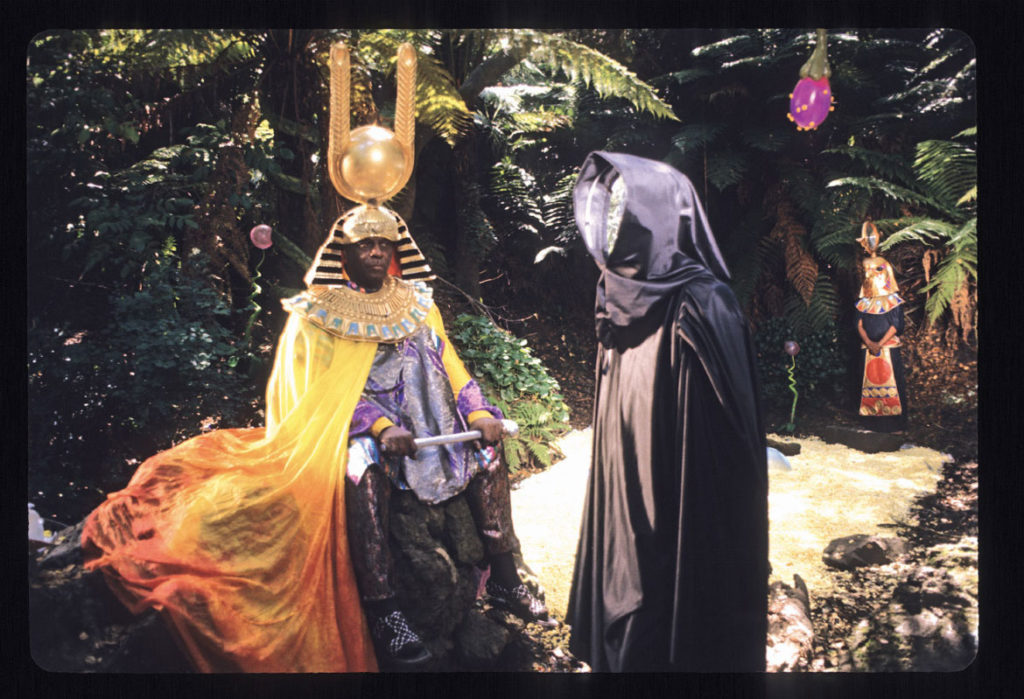 “Space is the Place Film Still,” 1974, by Jim Newman. “Sun Ra and his mysterious mirror-faced companion in Golden Gate Park. The photo is from the opening sequence of the film in which Sun Ra wanders a lush unspecified planet and outlines his theory on how we can move through space propelled by music, a theoretical way of travel he calls ‘trans-molecularization.’” (Courtesy Portland Art Museum)