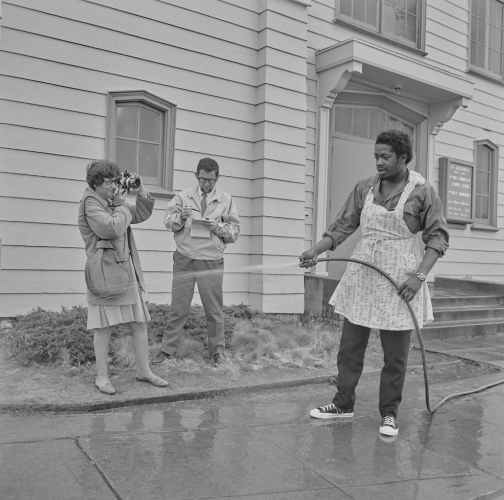 PirkleJones, "Ruth-Marion Baruch photographing Charles Bursey at the Black Panther Free Breakfast for Children Program, St. Augustine's Episcopal Church," May 19, 1969. (Courtesy University of California, Santa Cruz)