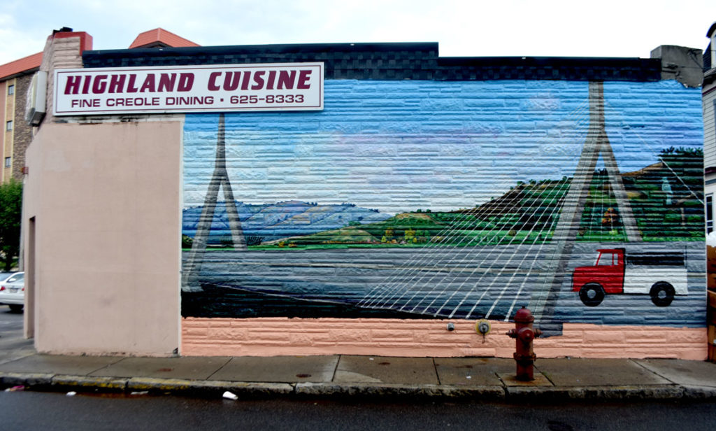 Pascal Michel's mural on the side of Highland Creole Cuisine, 2 Highland Ave., Somerville, on Aug. 21, 2019. (Greg Cook)
