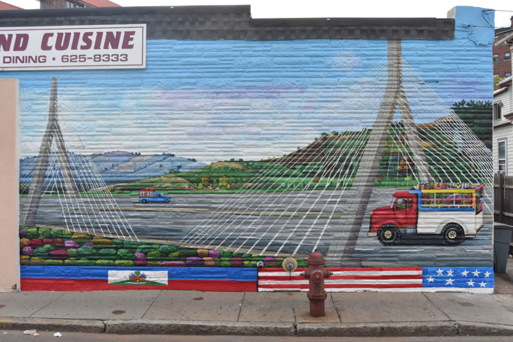 Pascal Michel's mural on the side of Highland Creole Cuisine, 2 Highland Ave., Somerville, on the morning of Aug. 28, 2019. (Greg Cook)
