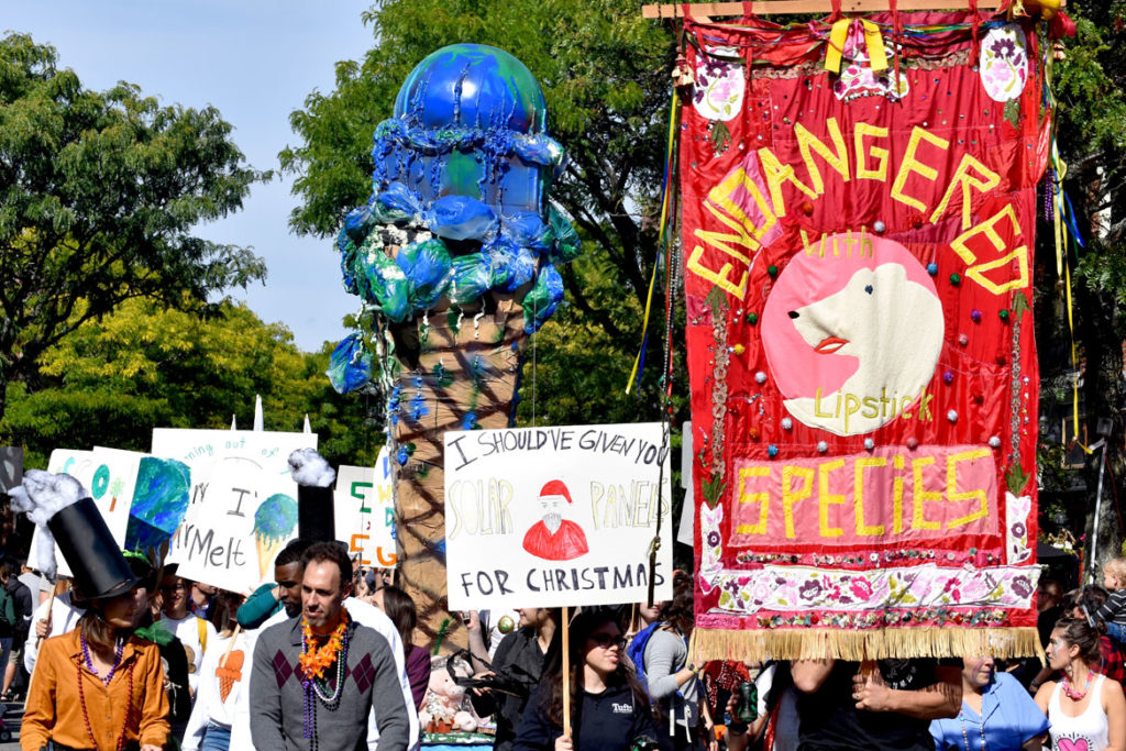 Global warming activists from Tufts University march through Somerville's Davis Square during the Honk Parade, Oct. 13, 2019. (Greg Cook photo)