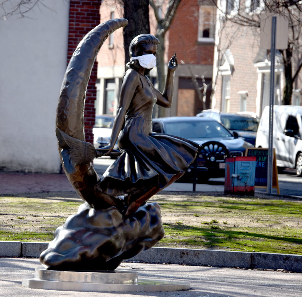 Bewitched statue on Washington Street in Salem in a coronavirus mask, April 4, 2020. (Greg Cook photo)
