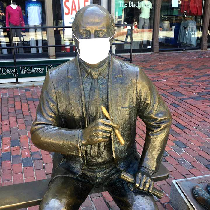 A protective mask has appeared on the 1985 statue of longtime Boston Celtics coach Red Auerbach by Lloyd Lillie outside Quincy Market at Faneuil Hall, c. April 6, 2020. (Courtesy)