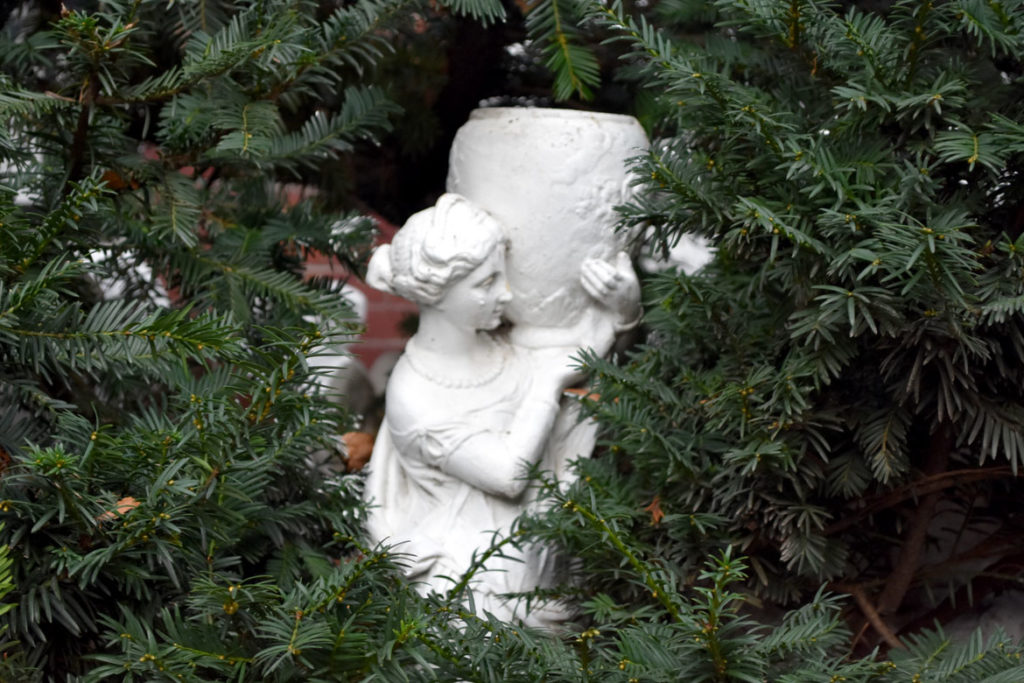 One of the sculptures hiding in the shrub in front of 9 Dwight St., Boston, Jan. 4, 2019. (Greg Cook photo)