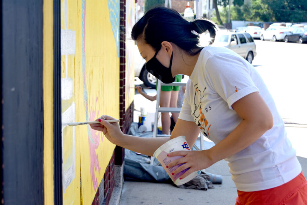 Rayna Lo painting mural at Wah Lum Kung Fu & Thai Chi Academy in Malden, July 29, 2020. (Photo ©Greg Cook)