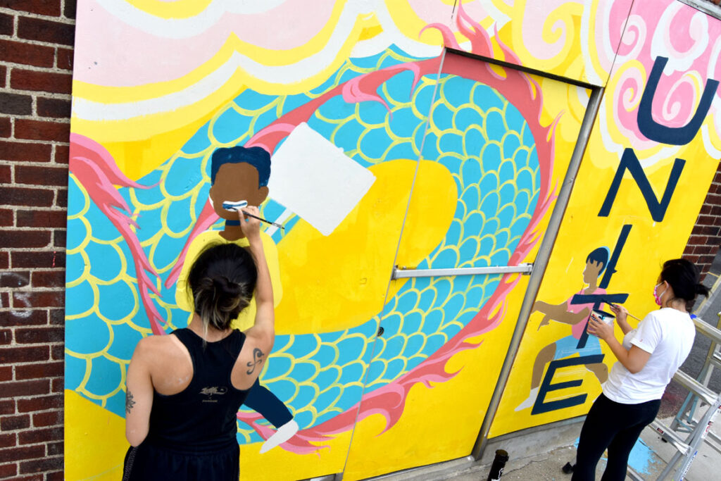 Shaina Lu (left) and Rayna Lo painting mural at Wah Lum Kung Fu & Thai Chi Academy in Malden, Aug. 8, 2020. (Photo ©Greg Cook)