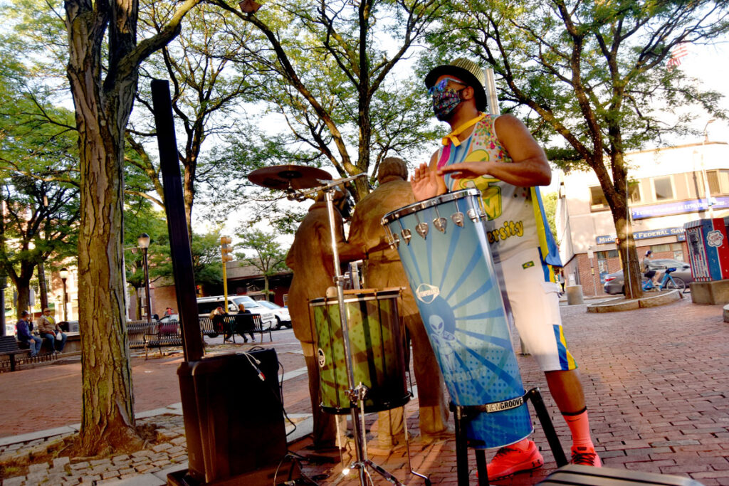 Marcus Santos of Grooversity drums in Somerville's Davis Square as part of a socially-distanced 2020 ArtBeat festival from the Somerville Arts Council, July 17, 2020. (©Greg Cook photo)