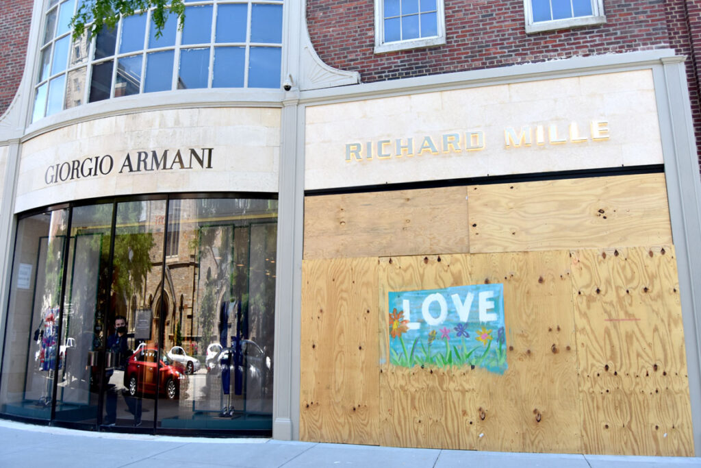 A Newbury Street boutique is boarded up after looting following a Black Lives Matter protest in downtown Boston on May 31, 2020. (©Greg Cook photo)