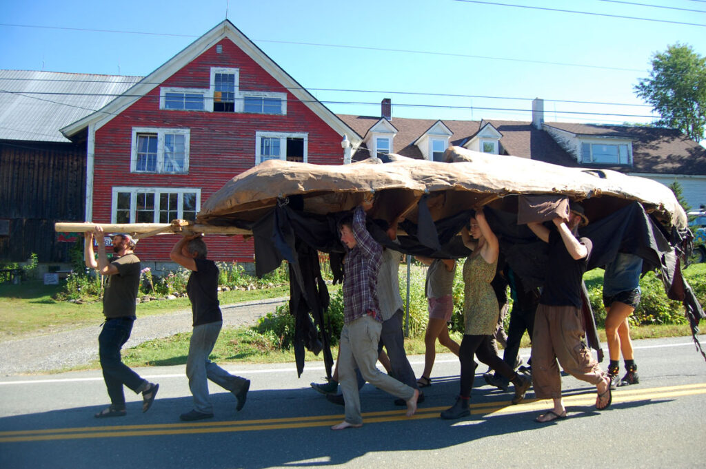 Remi Paillard (second from left) helps move the Mother Earth puppet head for the Bread and Puppet Pageant, Glover, Vermont, Aug. 22, 2015. (©Greg Cook photo)