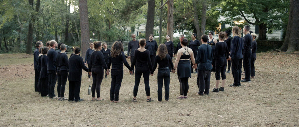 From “We Are Here” by Marc Levy and Marc Salomon of The Marcs: Paperhand Puppet Intervention circles up before performing their 2019 summer spectacle called “We Are Here” in North Carolina. (Courtesy of The Marcs)