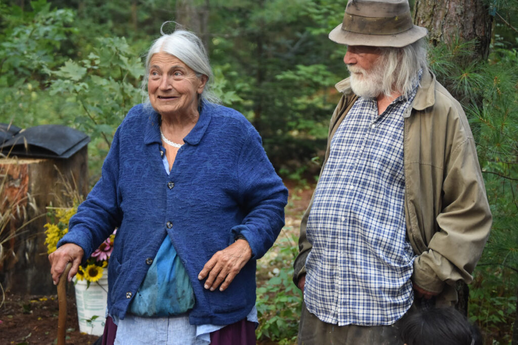 Elka and Peter Schumann in the pine forest at Bread and Puppet, Glover, Vermont, Aug. 18, 2018. (©Greg Cook photo)