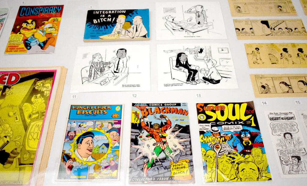 “It will be a while before the neighbors get used to you” (brick smashing through window) and other gag comics from Tom Floyd’s “Integration is a Bitch!” 1969; Daniel Clyne’s “Hungry Chuck Biscuits,” 1971; Tom Floyd’s “Blackman,” 1971; Richard “Grass” Green’s “Super Soul Comix #1,” 1972. In “Chicago Comics” at Chicago’s Museum of Contemporary Art, July 3, 2021. (©Greg Cook photo)