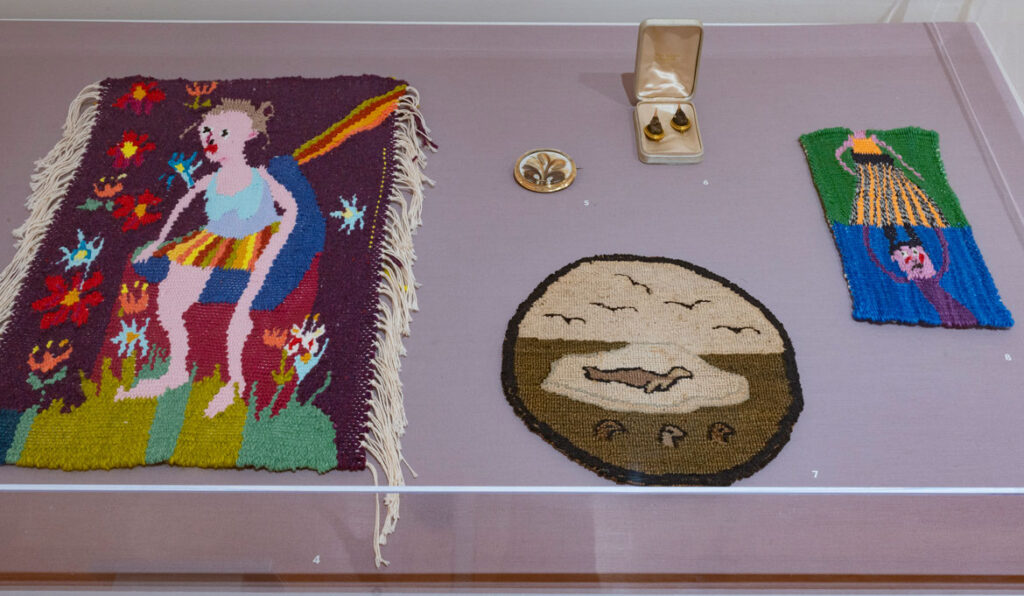 Christina Forrer artworks at left and right with broaches and polar bear table mat in between, at “Christina Forrer / MATRIX 187” at Wadsworth Atheneum Museum of Art, 2021. (Courtesy Wadsworth Atheneum Museum of Art)