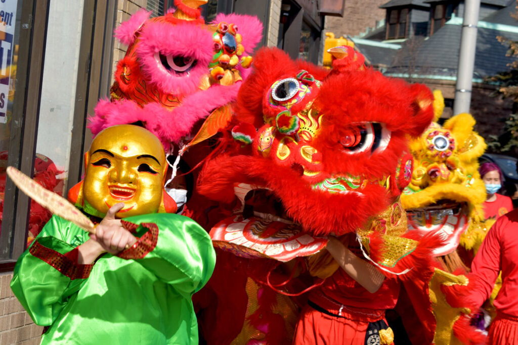Lions from Wah Lum Kung Fu & Tai Chi Academy dance in Malden to celebrate the Lunar New Year, Feb 12, 2022. (©Greg Cook photo)