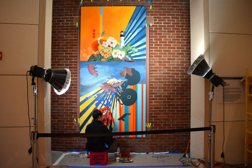 Silvia Lopez Chavez paints "Undercurrent" at the Peabody Essex Museum, March 12, 2022. It will be part of the exhibition "Climate Action: Inspiring Change," which is due to open at the Salem museum on April 16, 2022. (©Greg Cook photo)