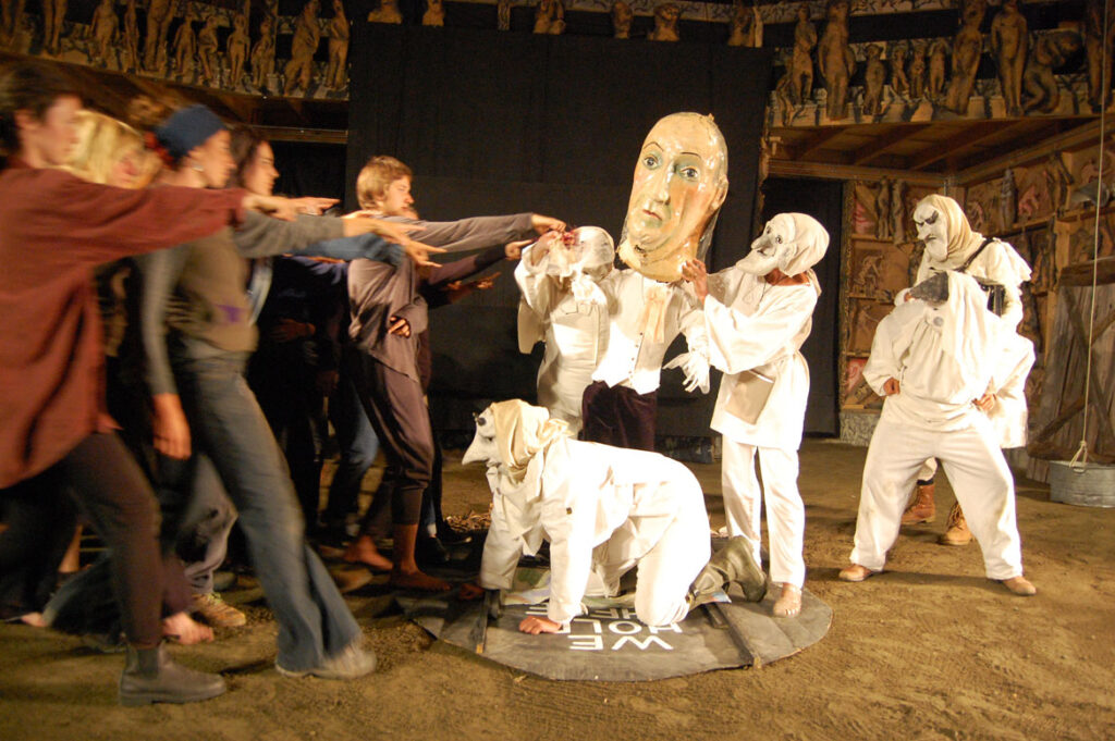 Genevieve Yeuillaz (masked, to right of Ben Franklin puppet) performs in Bread and Puppet's “The Seditious Conspiracy Theater Presents: A Monument to the Political Prisoner Oscar Lopez Rivera," Glover, Vermont, Aug. 22, 2015. (©Greg Cook photo)