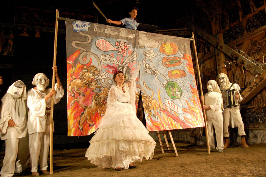 Genevieve Yeuillaz (masked, second from left) performs in Bread and Puppet's “The Seditious Conspiracy Theater Presents: A Monument to the Political Prisoner Oscar Lopez Rivera," Glover, Vermont, Aug. 22, 2015. (©Greg Cook photo)