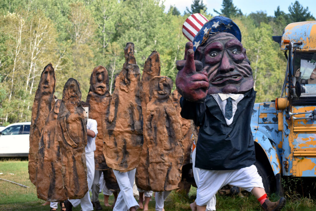 Bread and Puppet Theater performs an act about British government ordering the extradition of WikiLeaks founder Julian Assange to the United States to face spying charges. Part of its "Apocalypse Defiance Circus" in Glover, Vermont, Aug. 28, 2022. (© Greg Cook photo)