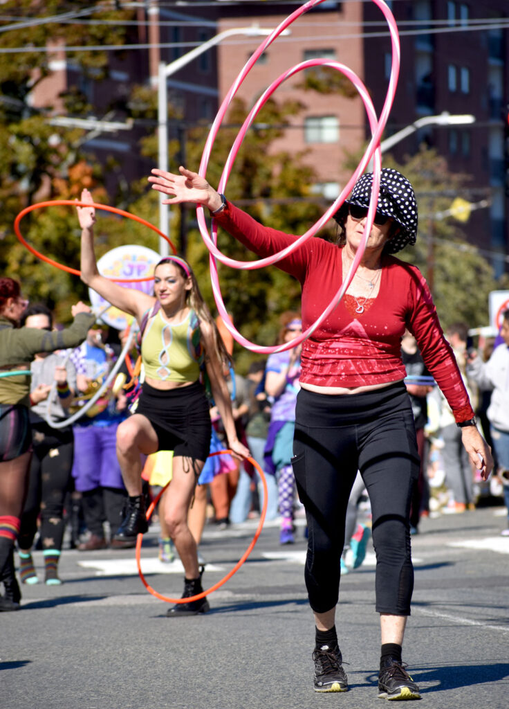 Boston Hoop Troop performs in the Honk parade from Somerville's Davis Square to Cambridge's Harvard Square, Sunday, Oct 9, 2022 (©Greg Cook photo)