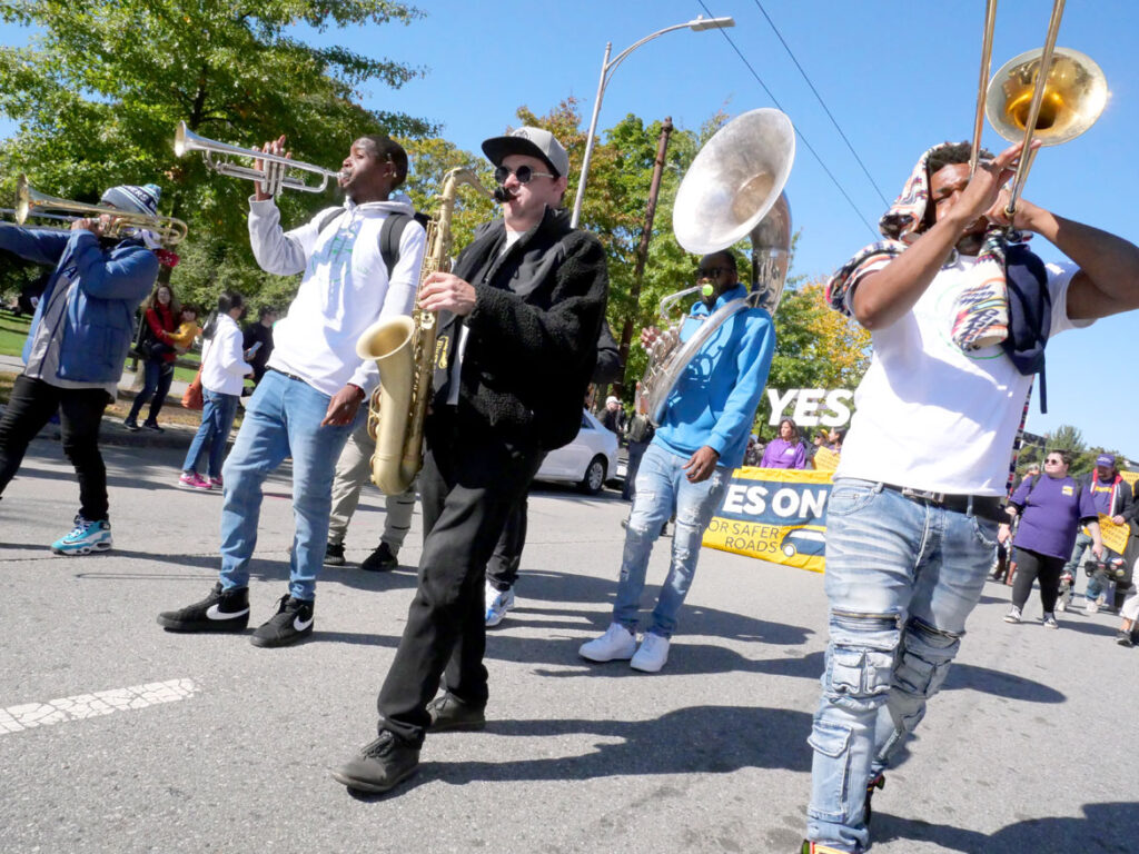 Young Fellaz Brass Band from New Orleans performs in the Honk parade from Somerville's Davis Square to Cambridge's Harvard Square, Sunday, Oct 9, 2022 (©Greg Cook photo)