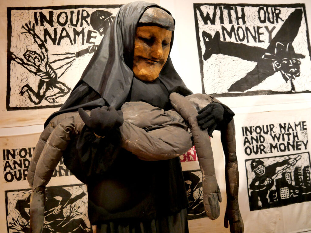 Iraqi woman mask in the exhibition “Bread and Puppet Theater: Art and Activism in Five Acts” at Salem State University, November 2022. (©Greg Cook photo)