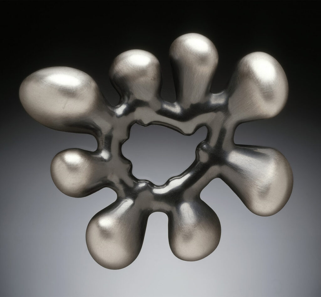 Joe Wood, "Loopy" Brooch in Brushed Silver, 2002, silver electroformed from 3D print with patina. (Photo by Dean Powell)