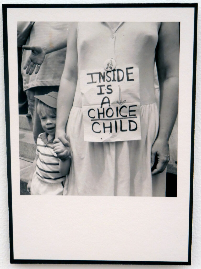 "Inside Is A Choice Child," protester against Webster v. Reproductive Health Services decision, reproduction of photo by Mary Ann McQuillan, July 1989. In "The Age of Roe: The Past, Present, and Future of Abortion in America" at Harvard Radcliffe Institute Schlesinger Library's Poorvu Gallery.