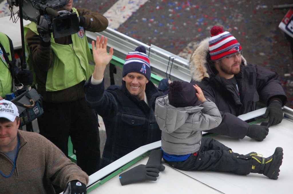 Tom Brady waves to the crowd along Tremont Street at Boylston Street. (Greg Cook)
