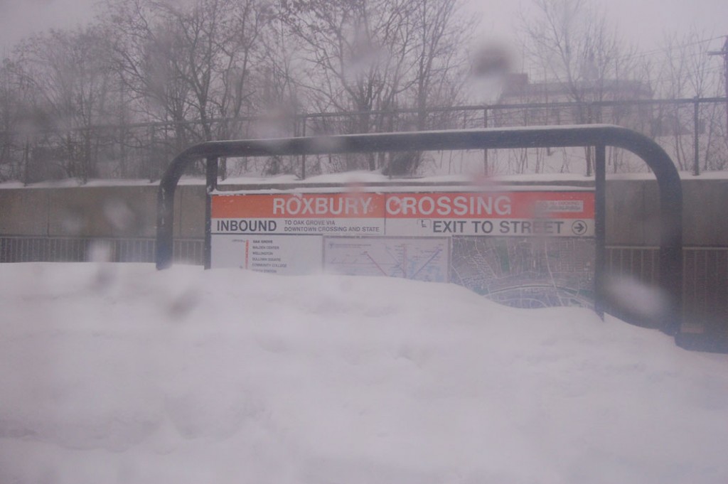 Roxbury Crossing sign buried in snow. (Greg Cook)