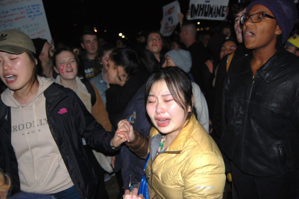 Crying and holding hands at "Protest Trump in Boston" at Boston Common, Nov. 9, 2016. (Greg Cook)