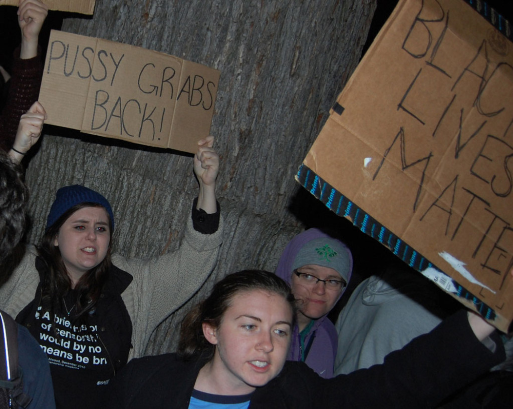 "Pussy Grabs Back." "Black Lives Matter." At "Protest Trump in Boston" at Boston Common, Nov. 9, 2016. (Greg Cook)
