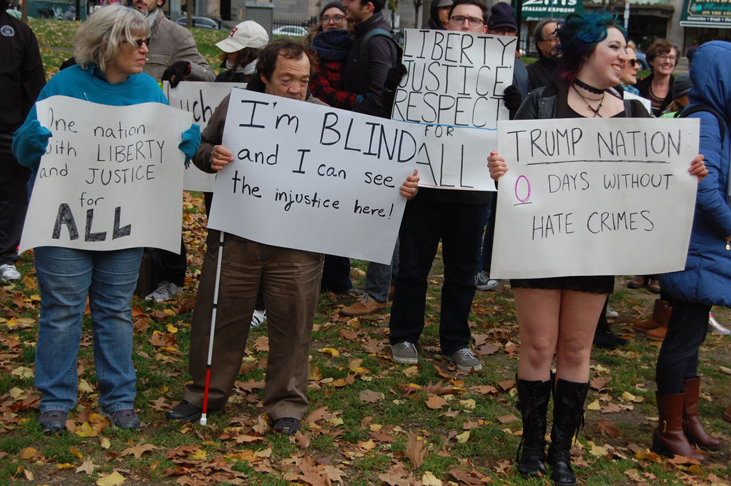 "One nation with liberty and justice for All." "I'm Blind and I can see the injustice here!" "Liberty, Justice, Respect for All." "Trump Nation: 0 days without hate crimes." At "Love Trumps Hate" rally at Boston Common, Nov. 20, 2016. (Greg Cook)