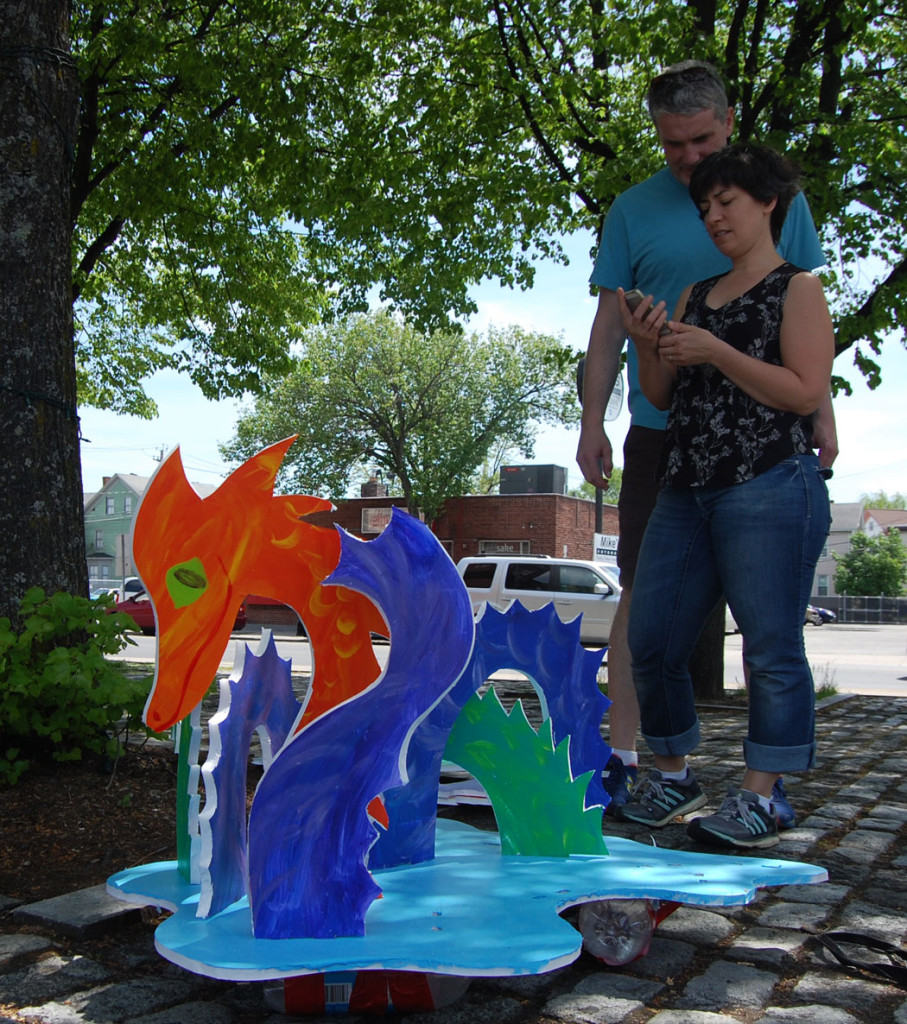 Cathy and Dan Moynihan ready Dan's sea monsters for the Tiny Tall Ships Festival in Somerville's Union Square, May 14, 2016. (©Greg Cook photo)