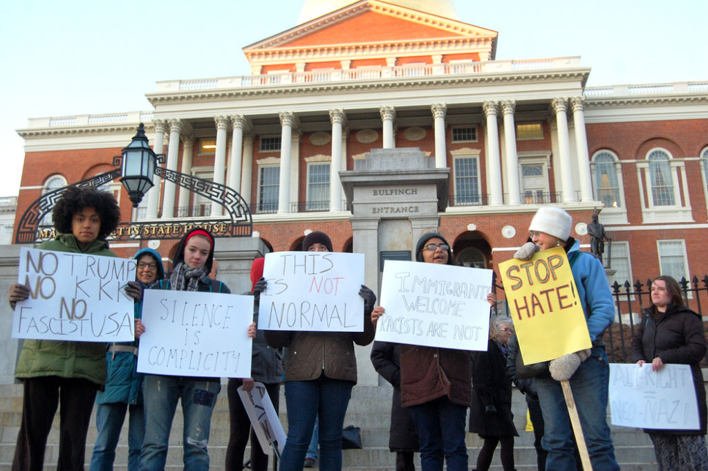"No Trump / No KKK / No Facist U.S.A." "Silence Is Complicity." "This Is Not Normal." "Immigrants Welcome / Racists Are Not." "Stop Hate!" "Alt-Right = Neo-Nazi." At "Protect Our White House" rally at Massachusetts State House in Boston, Dec. 9, 2016. (Greg Cook)