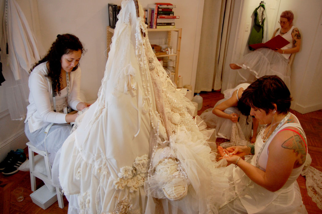 Samantha Fields's (foreground) performance in which people work on the white petticoat while others read texts by women about art, studio practice, feminst theory, queer theory, and the history of handwork. (Greg Cook)