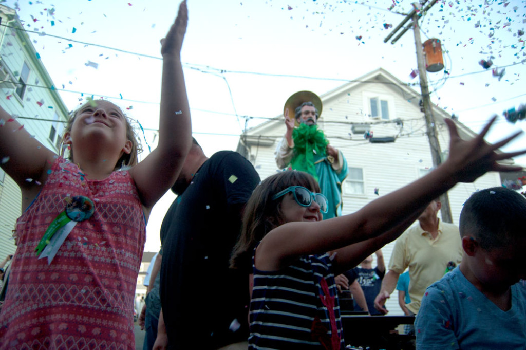 Trying to catch confetti during the St. Peter's Fiesta procession down to Beach Court, June 20, 2017. (Greg Cook)